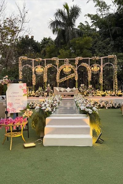 Home 5 Floral wedding stage decor with flower-lettered backdrop at Bali Pool Side lawn, Mallu Farms Chattarpur